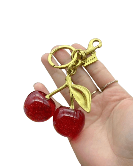Coach – Llavero Cherry Gold Edition (Dama)
